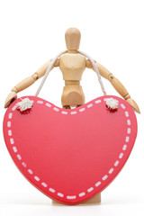 Wooden mannequin with large wooden red heart