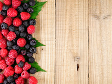 Pile Of Raspberry On Wooden Background