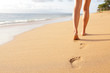 © Maridav - Beach travel - woman walking on sand beach closeup