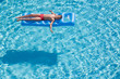 © Pavel Losevsky - boy floats on an inflatable mattress in pool face up