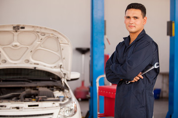 Wall Mural - Young mechanic at an auto shop