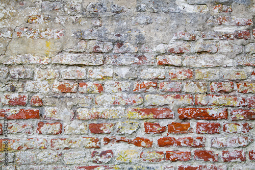 Fototapeta na wymiar Old Red Brick Wall with Cracked Concrete