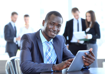 Portrait of a handsome young business man with a laptop