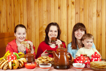 Wall Mural - Women  drinks tea and eats pancakes