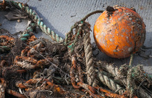 Old Tangled Fishing Nets With Orange Sphere Buoy