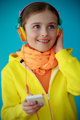 Wall Mural - Young girl enjoying music