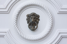 Lion Head Door Knocker On The White Door