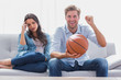 © WavebreakmediaMicro - Woman annoyed by her partner watching basketball game