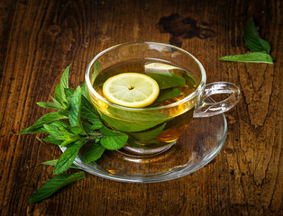 Poster - herbal mint tea on an old wooden table