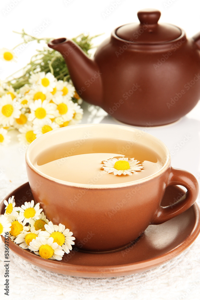 Cup of herbal tea with camomiles close up
