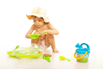 Cute toddler girl play with beach toys