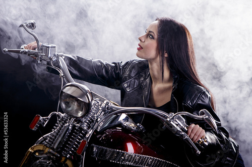 Fototapeta na wymiar Young woman on the motorcycle