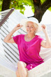 © Monkey Business - Senior Woman Relaxing In Beach Hammock
