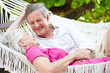 © Monkey Business - Senior Couple Relaxing In Beach Hammock