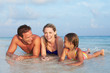 © Monkey Business - Family Lying In Sea On Tropical Beach Holiday