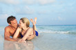 © Monkey Business - Romantic Couple Lying In Sea On Tropical Beach Holiday