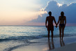 © Monkey Business - Silhouette Of Couple Walking Along Beach At Sunset