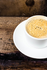 Poster - Closeup cup of espresso on old wooden table over grunge backgrou
