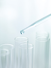 Wall Mural - liquid drop from pipette to test tubes