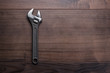 adjustable wrench on the wooden background