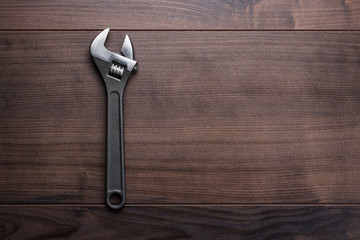 Wall Mural - adjustable wrench on the wooden background