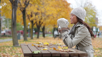 Wall Mural - Fall woman sitting in autumn park drinking coffee