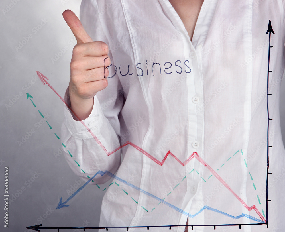 Woman paints graphic on glass on grey background