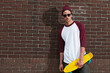 Urban fashion skateboarder with woolen hat and sunglasses in fro