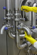 © endostock - hands in yellow gloves on tap and lever of technological system