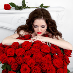 Wall Mural - Young beautiful woman leaning on the red roses bouquet. Valentin