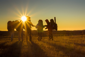 Wall Mural - Hikers is walking on plateau in Crimea mountains during sunset