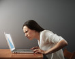 © ArtFamily - woman looking at laptop with distrust