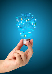 Light bulb in hand with technology business network