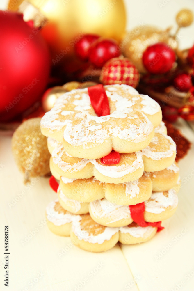 Christmas cookies and decorations on color wooden background