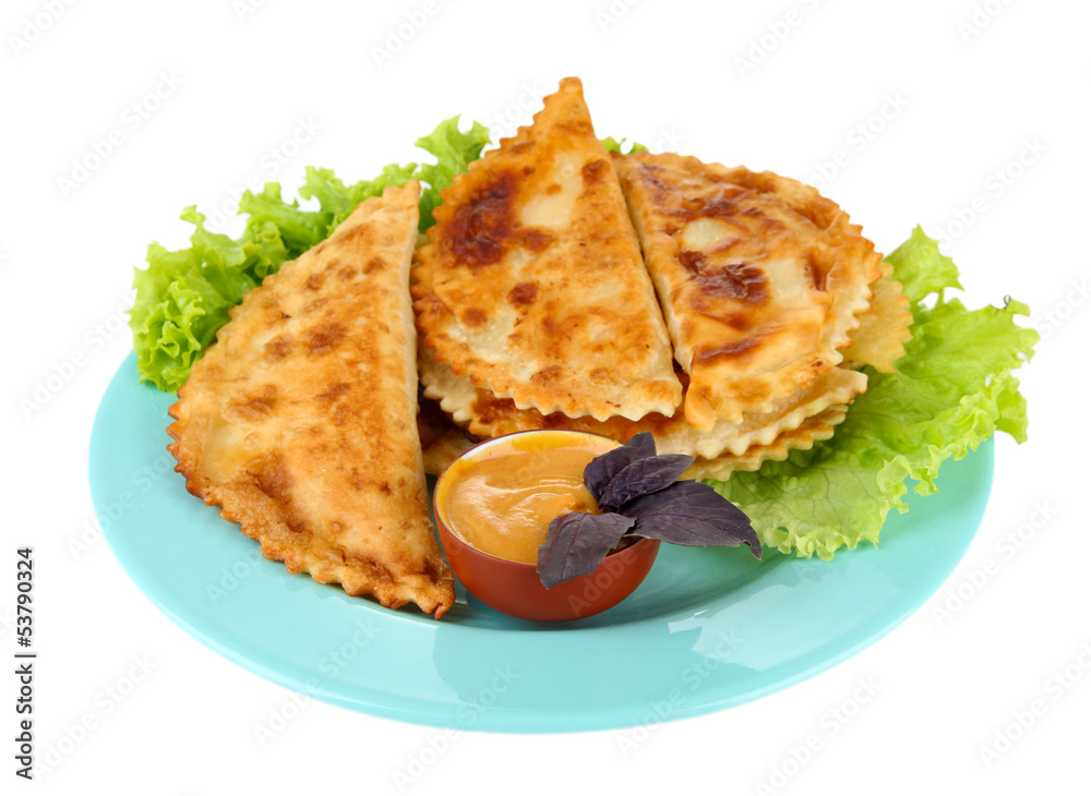 Tasty chebureks with fresh herbs on plate, isolated on white