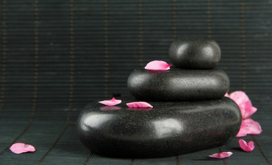 Poster - Spa stones and petals on bamboo background