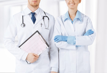 Wall Mural - nurse and male doctor holding cardiogram