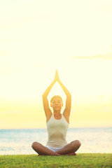 Yoga woman relaxing by sea