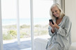 © onoky - Smiling woman using a mobile phone