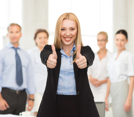 Poster - businesswoman with thumbs up in office