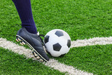 Fototapeta Sport - foot kicking soccer ball on corner