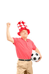 Sticker - Mature sport fan with hat holding a soccer ball and gesturing ha