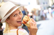Cheerful blond girl in Rome eating Focaccia sandwich