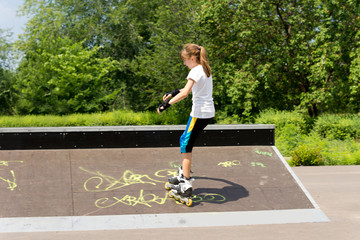 Young girl roller skating in the park