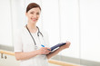 © BlueSkyImages - Young and talented doctor. Beautiful young female doctor holding