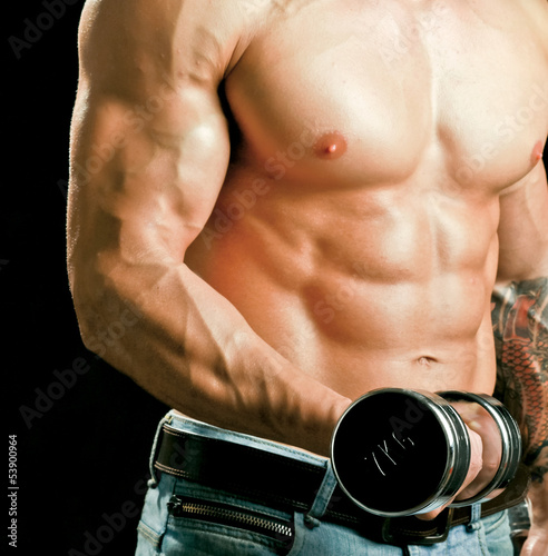 Obraz w ramie Handsome muscular man working out with dumbbells