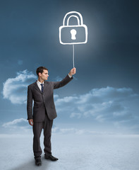 Poster - Businessman holding a floating padlock