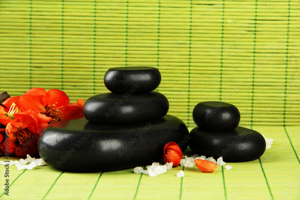 Spa stones and flowers on bamboo background