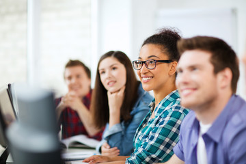 Canvas Print - students with computers studying at school