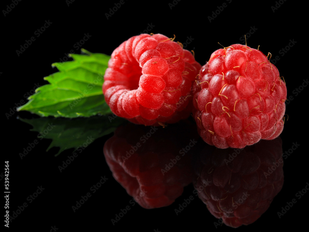 Ripe sweet raspberries on dark background